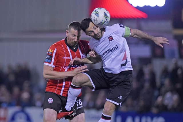 Derry’s Shane McEleney rises with Dundalk striker Patrick Hoban for this high ball. Photograph by Ciaran Culligan