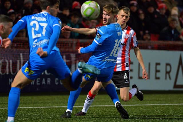 Derry City’s Ciaron Harkin chips the ball between Waterford pair Dean McMenamy and Kyle White. Photo: George Sweeney