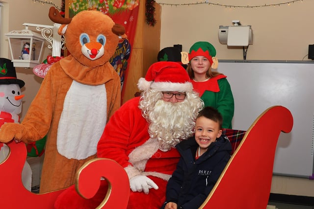 AJ pictured with Santa and his helpers at the Galliagh Community Christmas Craft Fair and Wonderland on Saturday afternoon.  Photo: George Sweeney