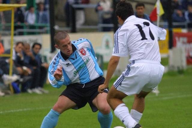 Tommy McCallion takes on a Real Madrid midfielder.