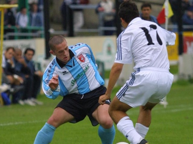 Tommy McCallion takes on a Real Madrid midfielder.