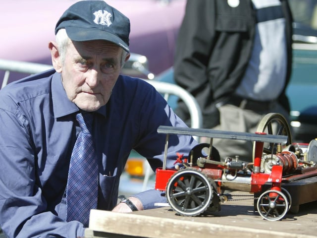 Local craftsman Mickey McLaughlin with one of fully working minature steam engines. (0908JB34) : Clonmany Festival, Vintage Show, Agricultural Show and Raft Race in August 2005.