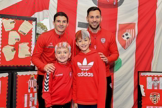 Faolán and Lorcán,from Gaelscoil Eadain Mhoir, pictured with Derry City’s Ciaran Coll and Pat Hoban during their visit to the school on Monday morning.  Photo: George Sweeney