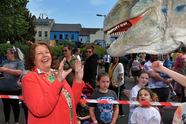 Mayor Patricia Logue encountered a Tyrannosaurus during her visit to the Long Tower Primary School Family Fun day on Friday afternoon. Photo: George Sweeney. DER2322GS – 112