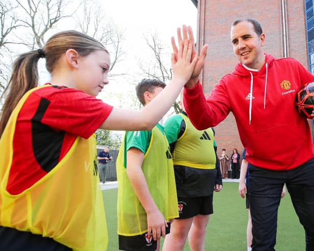 Former Man. Utd. and Republic of Ireland defender John O’Shea greets Millie and other Foundation participants at the start of the coaching session.