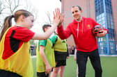 Former Man. Utd. and Republic of Ireland defender John O’Shea greets Millie and other Foundation participants at the start of the coaching session.