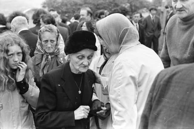 Mourners at the graveside.