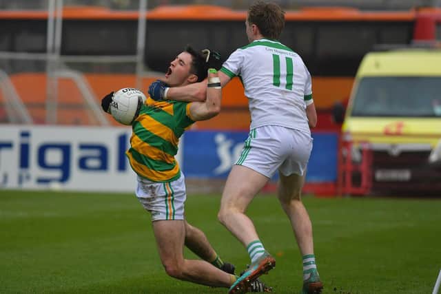 A high tackle by Con Magee’s Eoin Hynds brings down Diarmuid McNicholl of Glenullin. Photo: George Sweeney