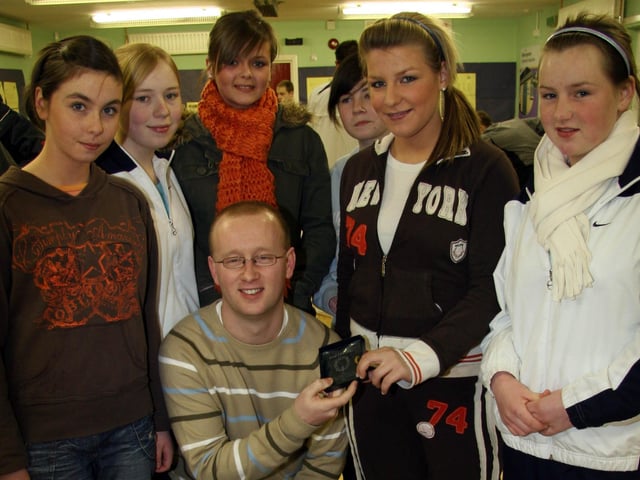 Girls form the Youth Club, Tasha McLaughlin, Jean McAuley, Melissa Deehan, Amy Nash, Alison Dalzell, Coleen McMonagle present John with a leaving Gift 0011JML : Parties and celebrations March 2006: John Leonard.
