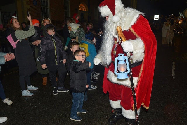 Santa greeting children at the Derry Christmas procession on Sunday evening last. Photo: George Sweeney. DER2248GS -  24