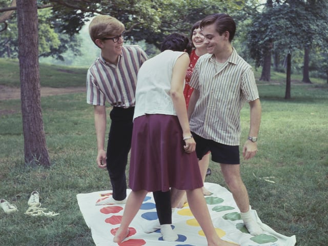 Twister has been giving people of all ages a work out for generations, like these teenagers back in the day. (Photo by F. Roy Kemp/BIPS/Hulton Archive/Getty Images)