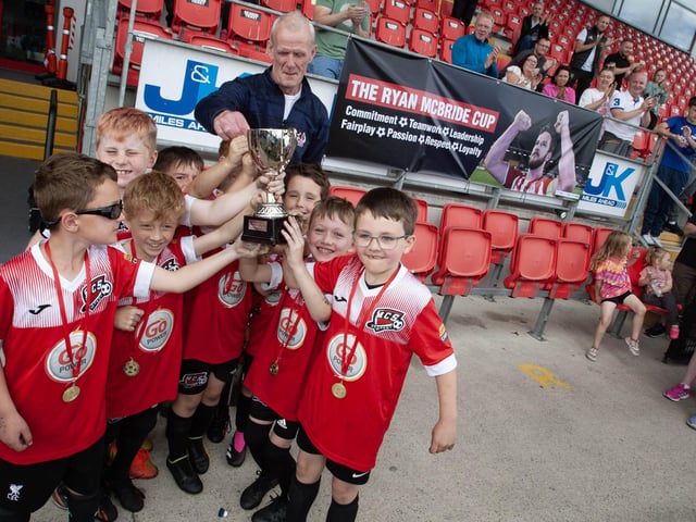 Maiden City Soccer receiving the Ryan McBride Cup from Lexie McBride, Ryan's father at the Brandywell on Wednesday afternoon. The tournament was part of Feile 23.