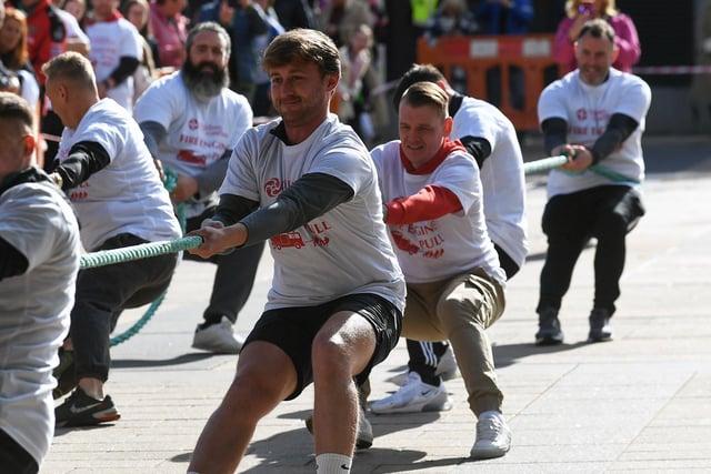 Fundraising team members pull a 32-tonne City of Derry Airport Fire and Rescue Engine, in Guildhall Square, in aid of Children In Crossfire.  Photo: George Sweeney