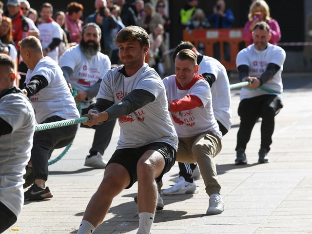 Fundraising team members pull a 32-tonne City of Derry Airport Fire and Rescue Engine, in Guildhall Square, in aid of Children In Crossfire. Photo: George Sweeney
