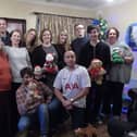 Fiona, middle row, far left, with her husband and children.