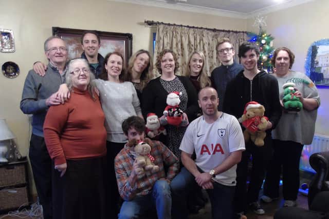 Fiona, middle row, far left, with her husband and children.