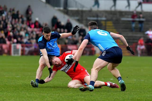 Ethan Doherty is intercepted by Dublin's Lee Gannon and John Small during the League game in Celtic Park. Photo: George Sweeney. DER2309GS – 47