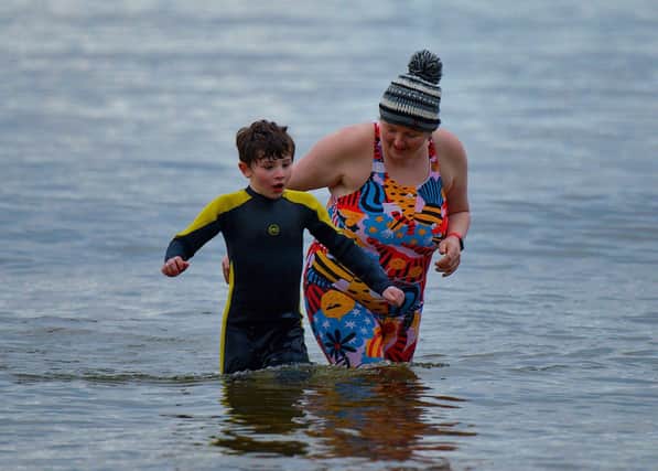 Swimmers brave the elements to take part in the annual ARC Fitness New Year's Day Charity Swim at Lisfannon beach.  Photo: George Sweeney. DER2301GS  08
