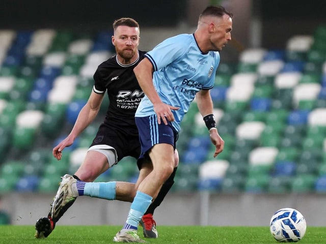 Brian Rainey closes down his Enniskillen opponent during Friday's fonaCAB Craig Stanfield Irish Junior Cup final at Windsor Park. (Photo: IFA)