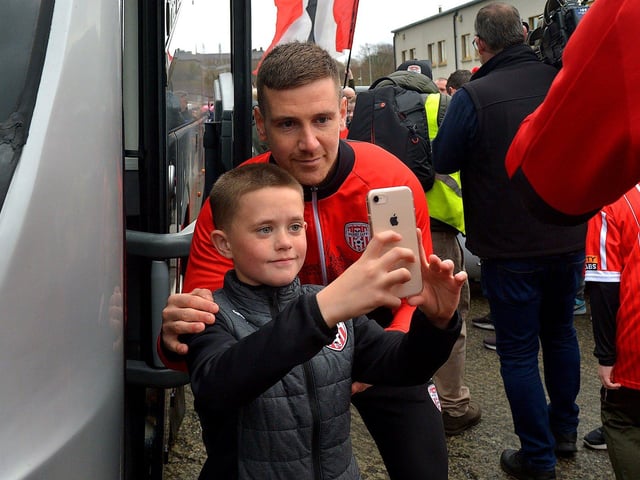 Derry City’s captain has his picture taken with a fan on Saturday morning prior to the team’s departure for Dublin ahead of tomorrow’s FAI Cup Final against Shelbourne. George Sweeney. DER2244GS – 55