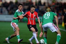 Ben Doherty takes on two Cork City players during Friday night's 2-0 win at Brandywell. Photo by Kevin Moore.