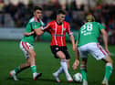 Ben Doherty takes on two Cork City players during Friday night's 2-0 win at Brandywell. Photo by Kevin Moore.