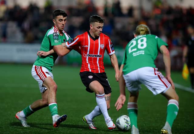Ben Doherty takes on two Cork City players during Friday night's 2-0 win at Brandywell. Photo by Kevin Moore.
