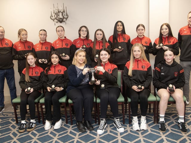Phoenix Flames u-15s receive the Winter Cup from Kerri Pyne, Derry Credit Union, at the D&D Youth FA awards at the Waterfoot Hotel on Sunday night last. Included are Ben Jackson and Paul Dorran. (Photos: Jim McCafferty Photography)
