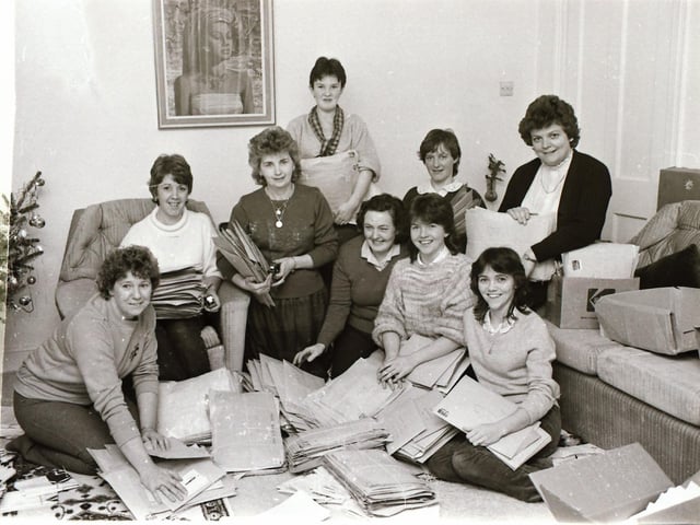 Ladies preparing Mini Marathon entries for posting to competitors.
