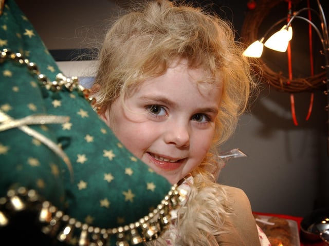 Helena McLaughlin finds a hand crafted Christmas tree at the Greencastle Craft Fair held at the Maritime Museum. (0612PG54) : Christmas in Inishowen in 2005.
