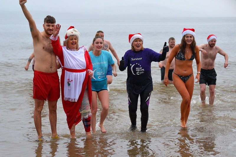 Swimmers brave the elements to take part in the annual Christmas morning charity swim at Ludden beach. Photo: George Sweeney. DER2252GS – 15
