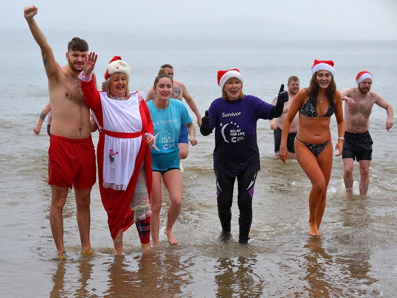 Swimmers brave the elements to take part in the annual Christmas morning charity swim at Ludden beach. Photo: George Sweeney. DER2252GS – 15