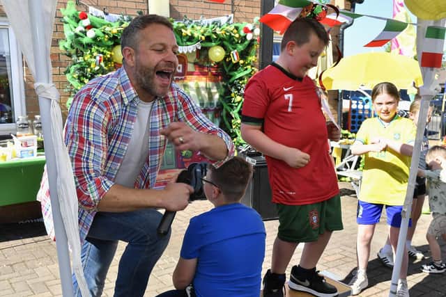Musician and singer Ritchie Remo and Carter boogie during the Annual Farland Way Hazelbank Big Lunch. Photo: George Sweeney