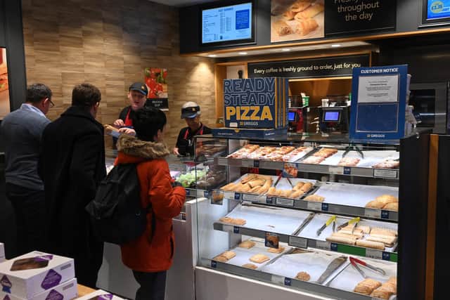 People queue at a counter inside a Greggs bakery in central London on March 5, 2024. (Photo by JUSTIN TALLIS/AFP via Getty Images)