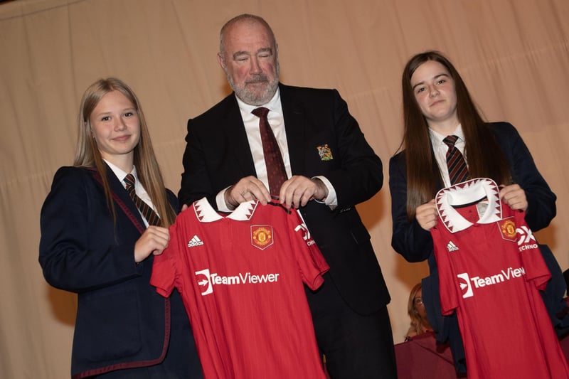 Ava and Courtney, Year 11 students,  receive the Manchester United Foudnation prizes for contribution to school activities from Mr. John Shiels, CEO, Manchester United Foundation during last week's prizegiving at Oakgrove College.