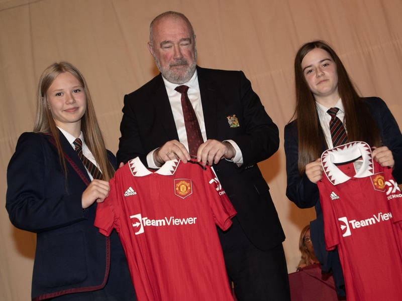 Ava and Courtney, Year 11 students,  receive the Manchester United Foudnation prizes for contribution to school activities from Mr. John Shiels, CEO, Manchester United Foundation during last week's prizegiving at Oakgrove College.