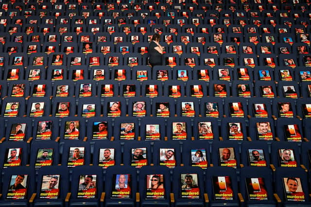 TEL AVIV, ISRAEL - OCTOBER 22: Pictures of over 1,000 persons abducted, missing or killed in the Hamas attack are displayed on empty seats in the Smolarz Auditorium at Tel Aviv University on October 22, 2023 in Tel Aviv, Israel. (Photo by Leon Neal/Getty Images)