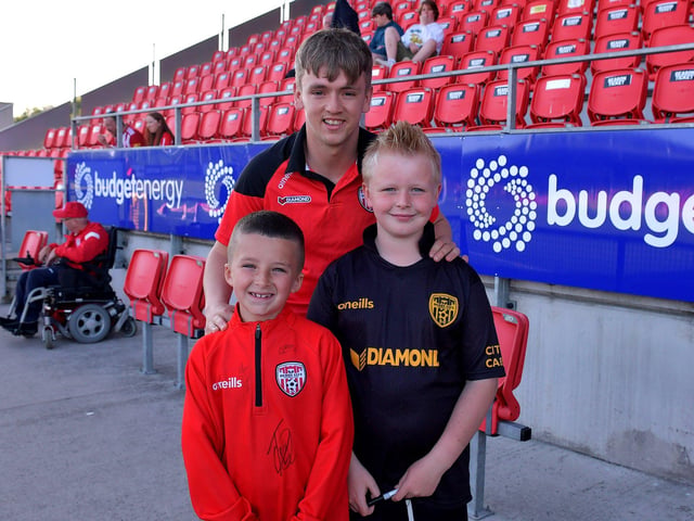 Young fans pictured with Derry City’s Ciaron Harkin, before the game against Shelbourne, on Friday night. Photo: George Sweeney. DER2321GS - 55