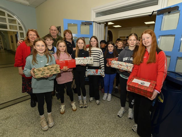 Pupils from Lumen Christi College pictured with some of the hundreds of Christmas presents for Ukrainian children donated by pupils, their families and friends. Included in the photograph are teacher Mrs Bronagh Peter Jennings, Derry Ukraine Aid, Deputy Mayor Alderman Niree McMorris. Photo: George Sweeney