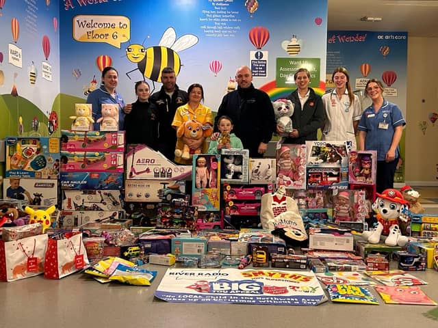 River Radios Director Gerard Doherty and his 7-year-old daughter Yazmin Doherty (Toy Appeal founder) are pictured centre with Cathy Grady, Play Specialist Children's Ward, accompanied by Charity Partner The Salvation Army’s Captain Sharron and Keith Gamble and his daughter Ellie from The Bear Run 74 Charity and their team bringing toys to the Children’s Ward at Altnagelvin Hospital.