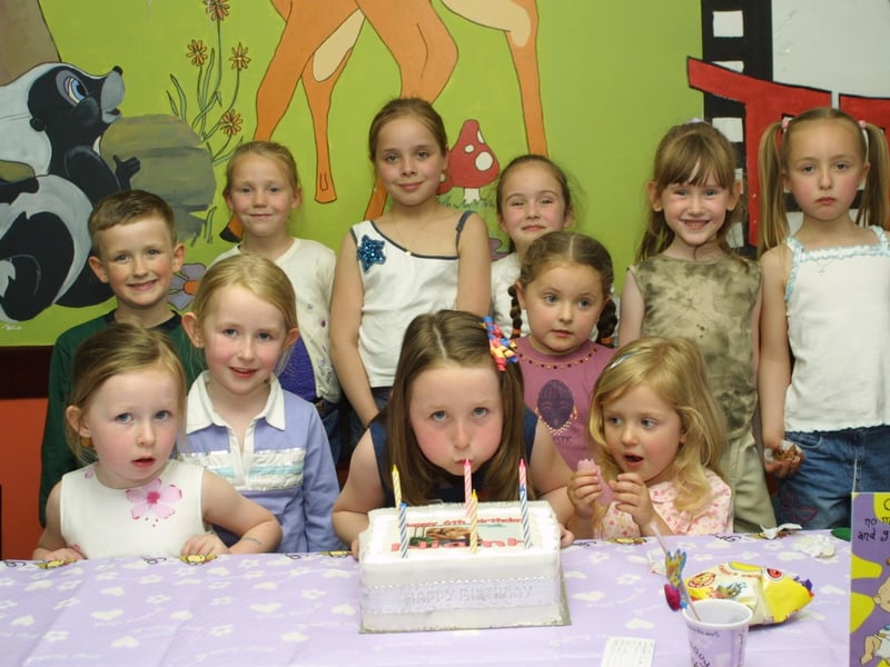 Niamh blows out the candles with the help of her friends.