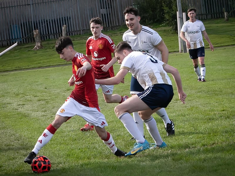 Dylan Saunders stretching to keep the ball in play during their game against Magee (UU) students at St. Joseph's Boys School.