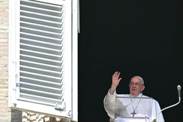 Pope Francis waves to the crowd during the Sunday Angelus prayer in St.Peter's Square at the Vatican on October 15, 2023. (Photo by ALBERTO PIZZOLI/AFP via Getty Images)