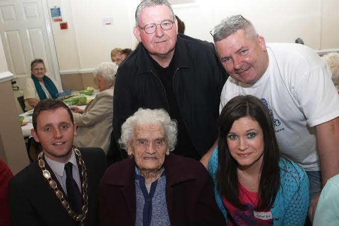 Alderman Gary Middleton, Deputy Mayor of Derry, Councillor Tony Hassan, Ollie Green, Festival Director and Louise Hughes, Community Empowerment Officer, Earhart Festival, with Mrs. Julia Faherty, who had reached the ripe age of 100, at a Tea Dance. DER2914MC073
