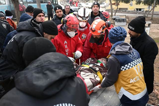 Rescue personnel stretcher a survivor as they search for victims and survivors through the rubble of buildings in Kahramanmaras, near the quake's epicentre, the day after a 7.8-magnitude earthquake struck the country's southeast, on February 6, 2023. Photo by OZAN KOSE / AFP) (Photo by OZAN KOSE/AFP via Getty Images)