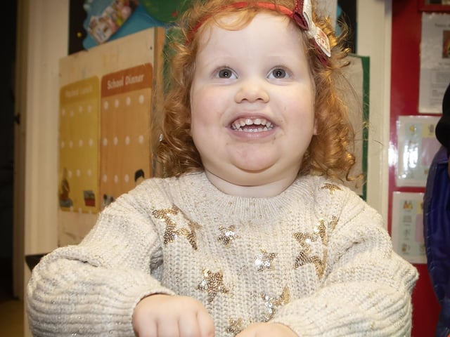 Two years old Laura Farrant having fun with her gingerbread man on Thursday at Oakgrove's Open Day. : .