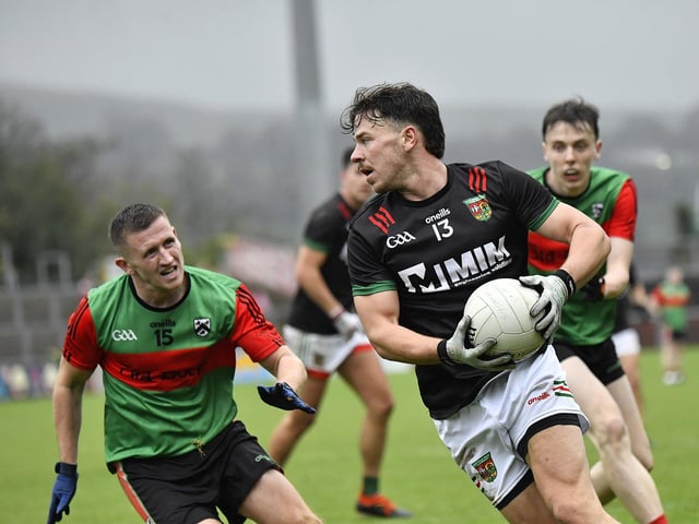 Doire Trasna’s Tomas McCrossan closes in on Killene Thorton of Slaughtmanus. Photo: George Sweeney
