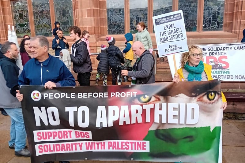 People Before Profit members with a banner at the rally on Saturday.
