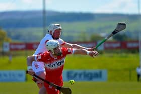 Derry’s Dara Mooney and Tyron’s Dean Rafferty contest a loose sliothar. Photo: George Sweeney