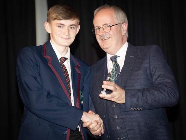 Stephen McGonagle receiving award for Sports Boy of the Year from Mr. Harkin, Principal.